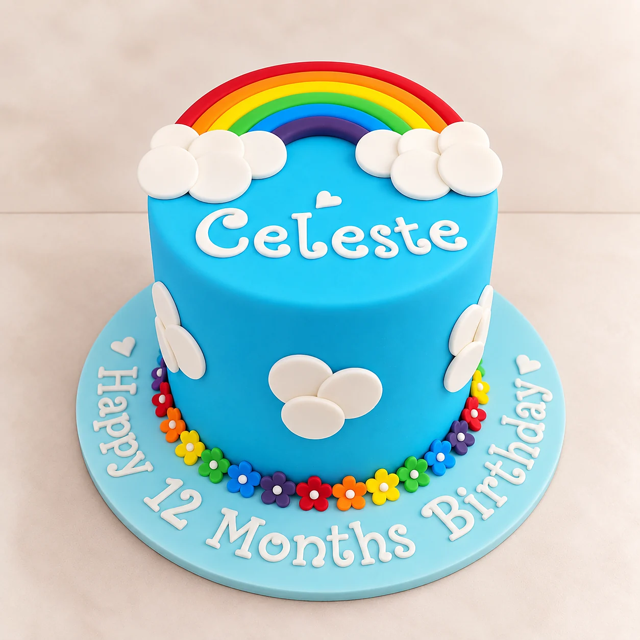Blue rainbow birthday cake with Celeste inscription