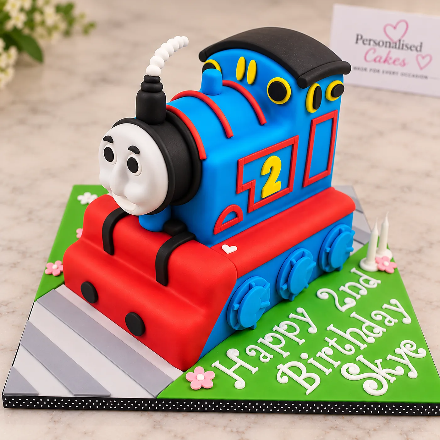 Blue and red Thomas the Tank Engine second birthday cake