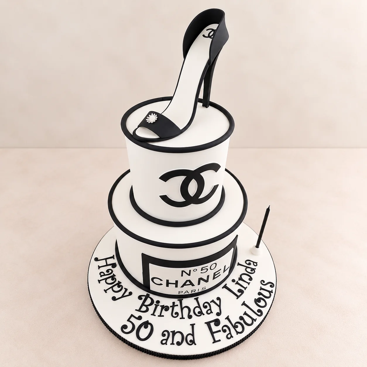 Black and white Chanel 50th birthday cake with a sculpted high heel